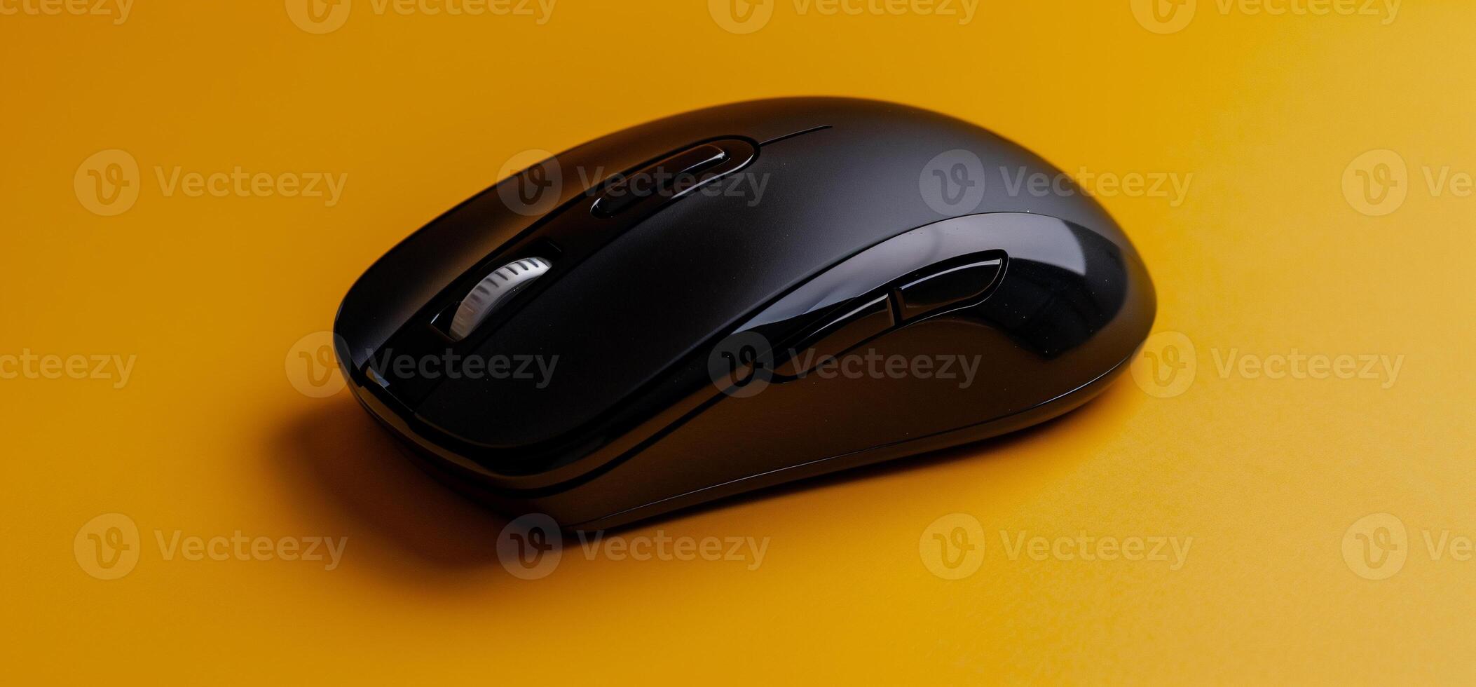 Black Wireless Computer Mouse on Orange Background photo