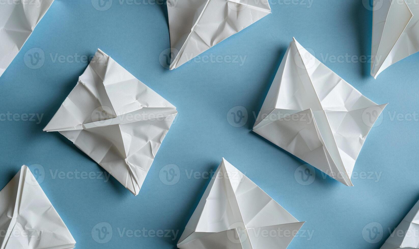 Folded paper airplanes on a light blue background photo
