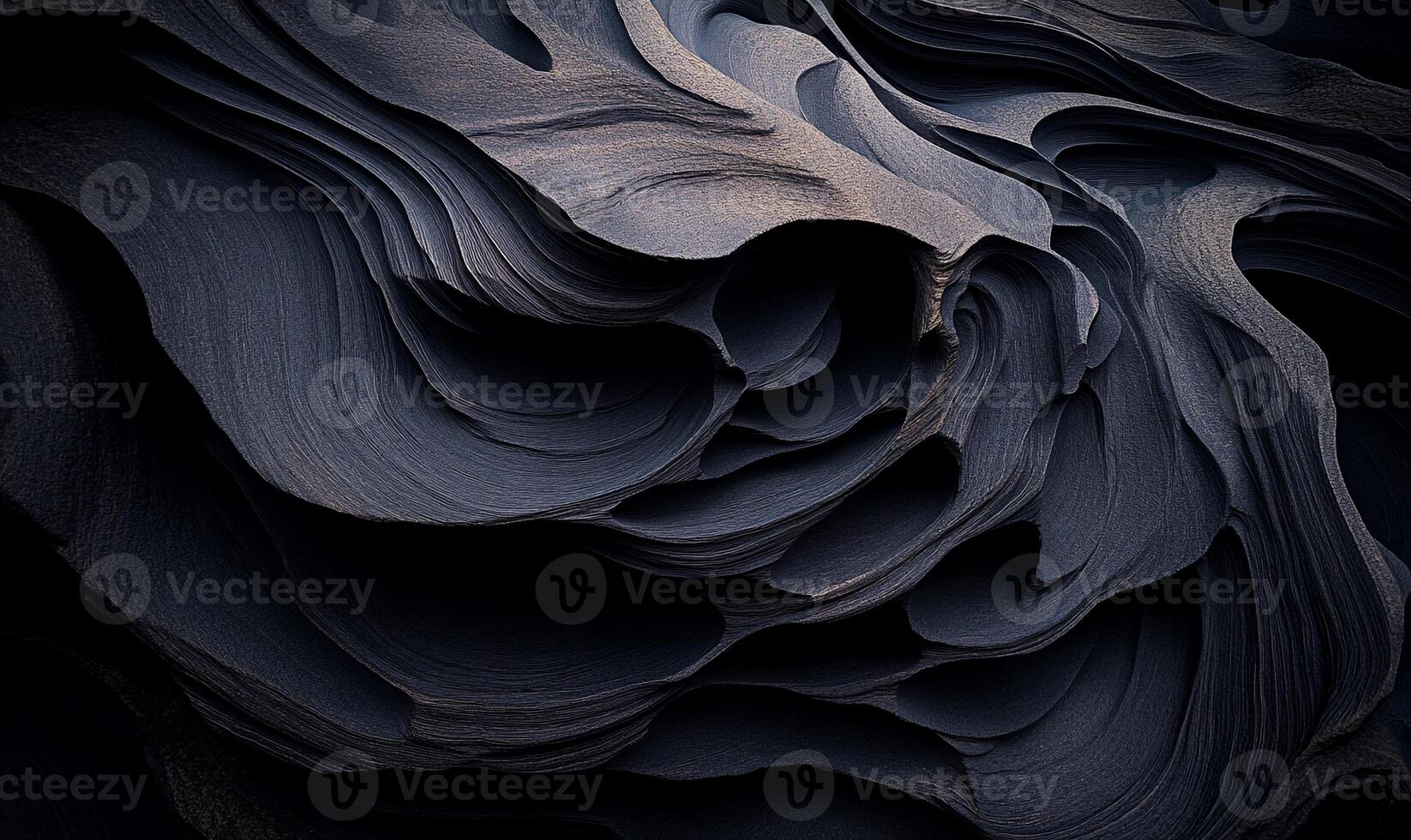 Dark, layered rock formations. Intricate, sculpted, geological textures photo