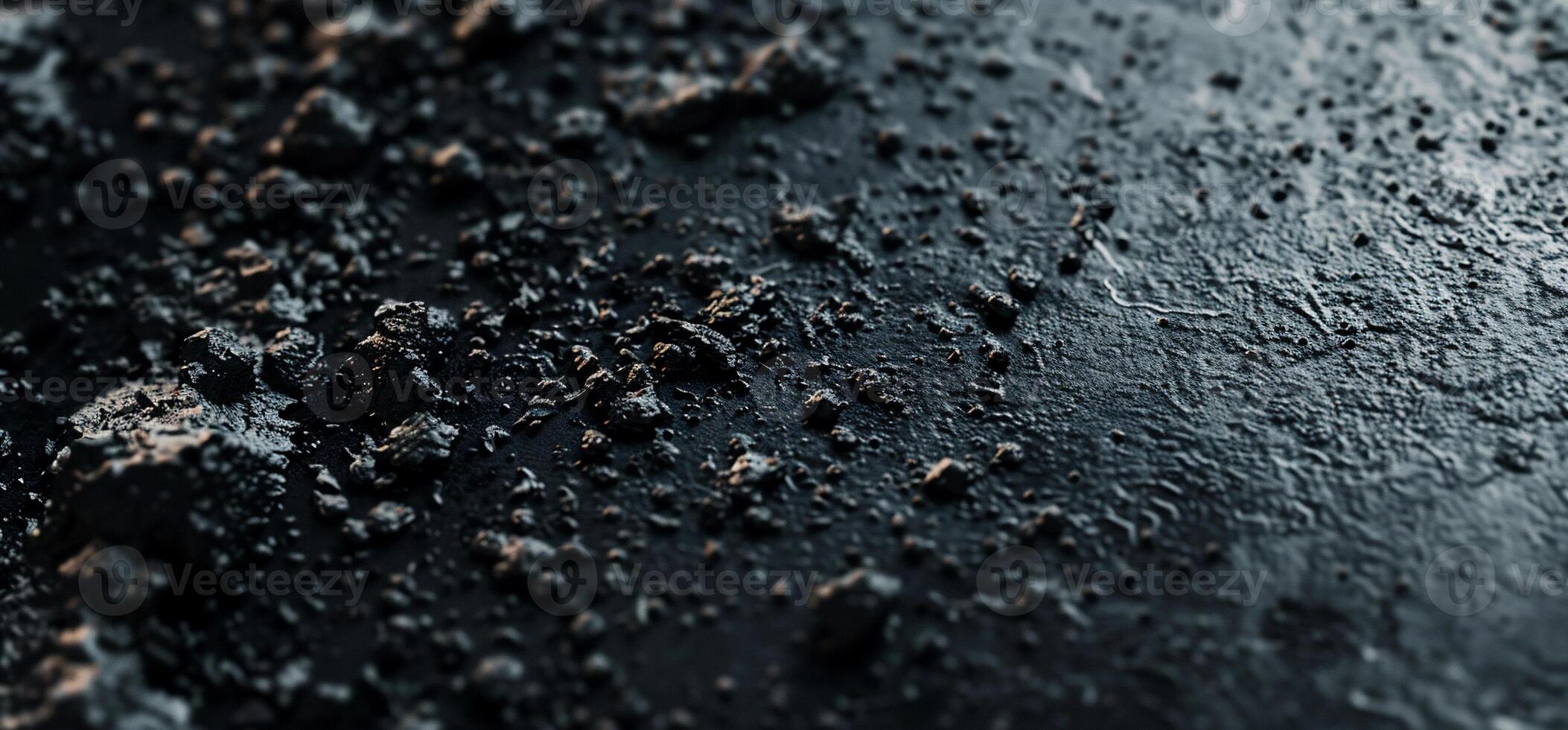 A close up of a black surface with dirt and water photo