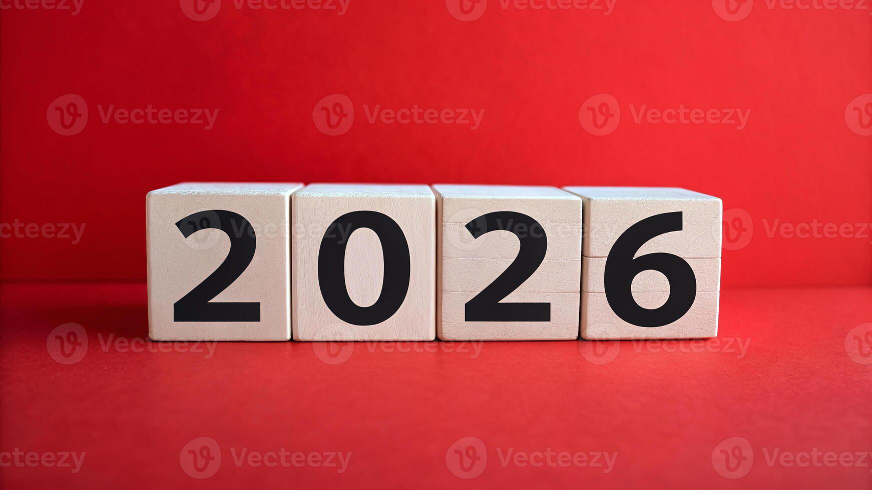 Countdown to the year 2026 with wooden blocks against a vibrant red backdrop photo