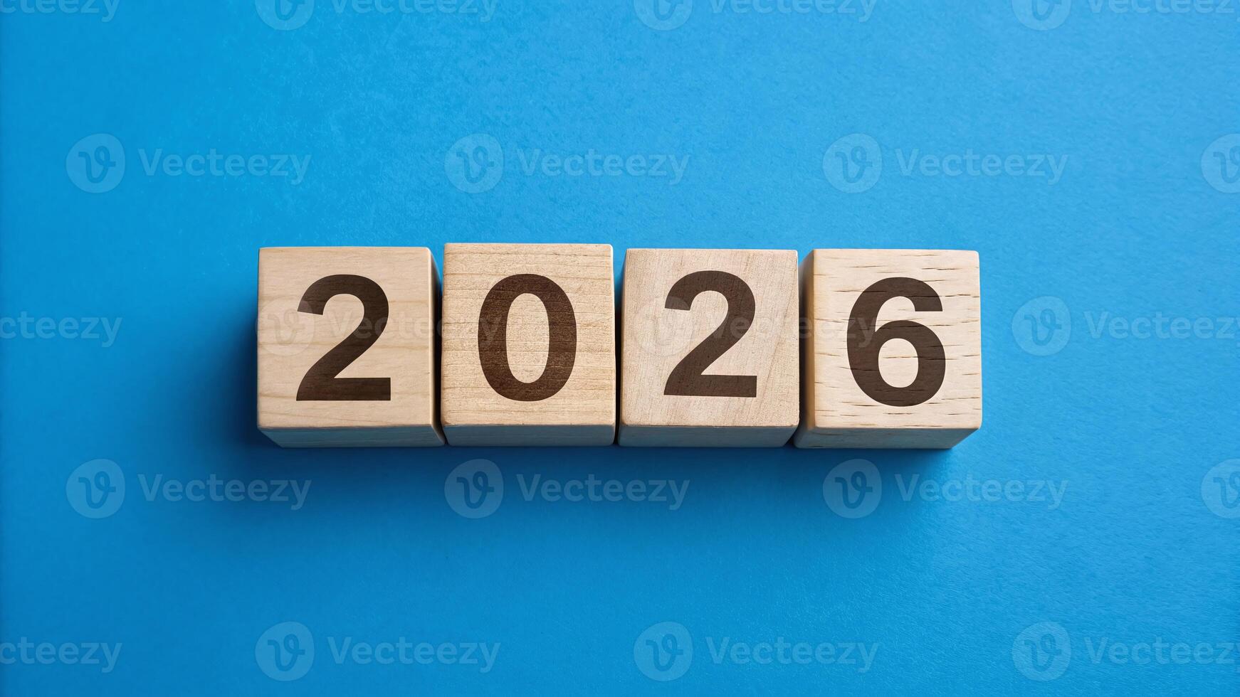 Wooden blocks displaying the year 2026 on a blue background for new year celebration photo