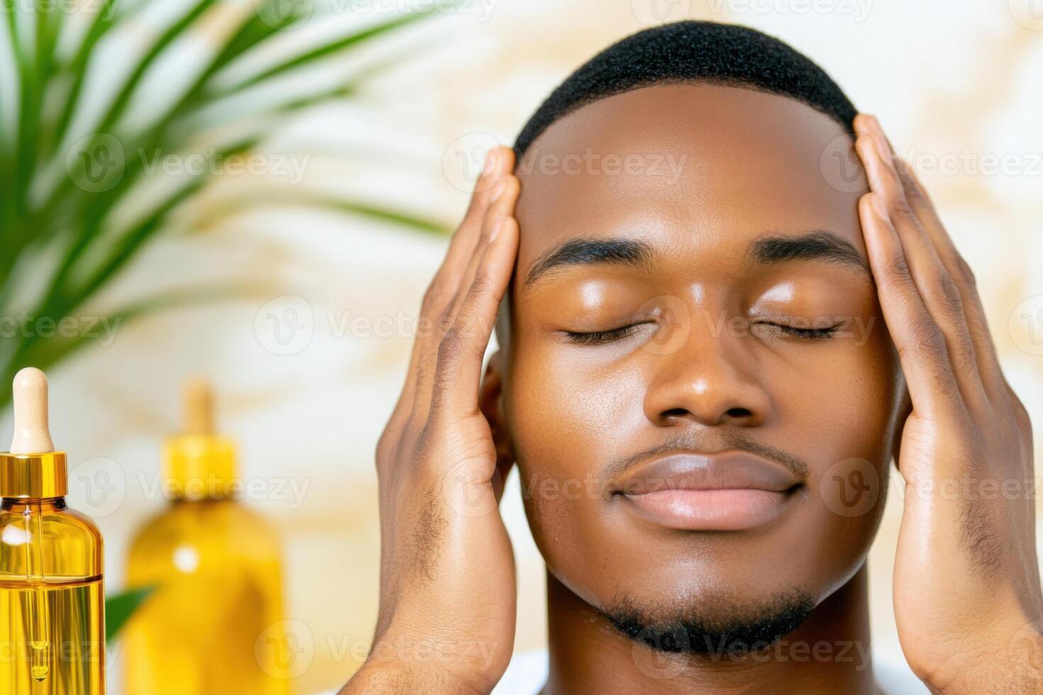 Bald Black man enjoys self-care by massaging his scalp with essential oils in a neutral-toned bathroom setting photo
