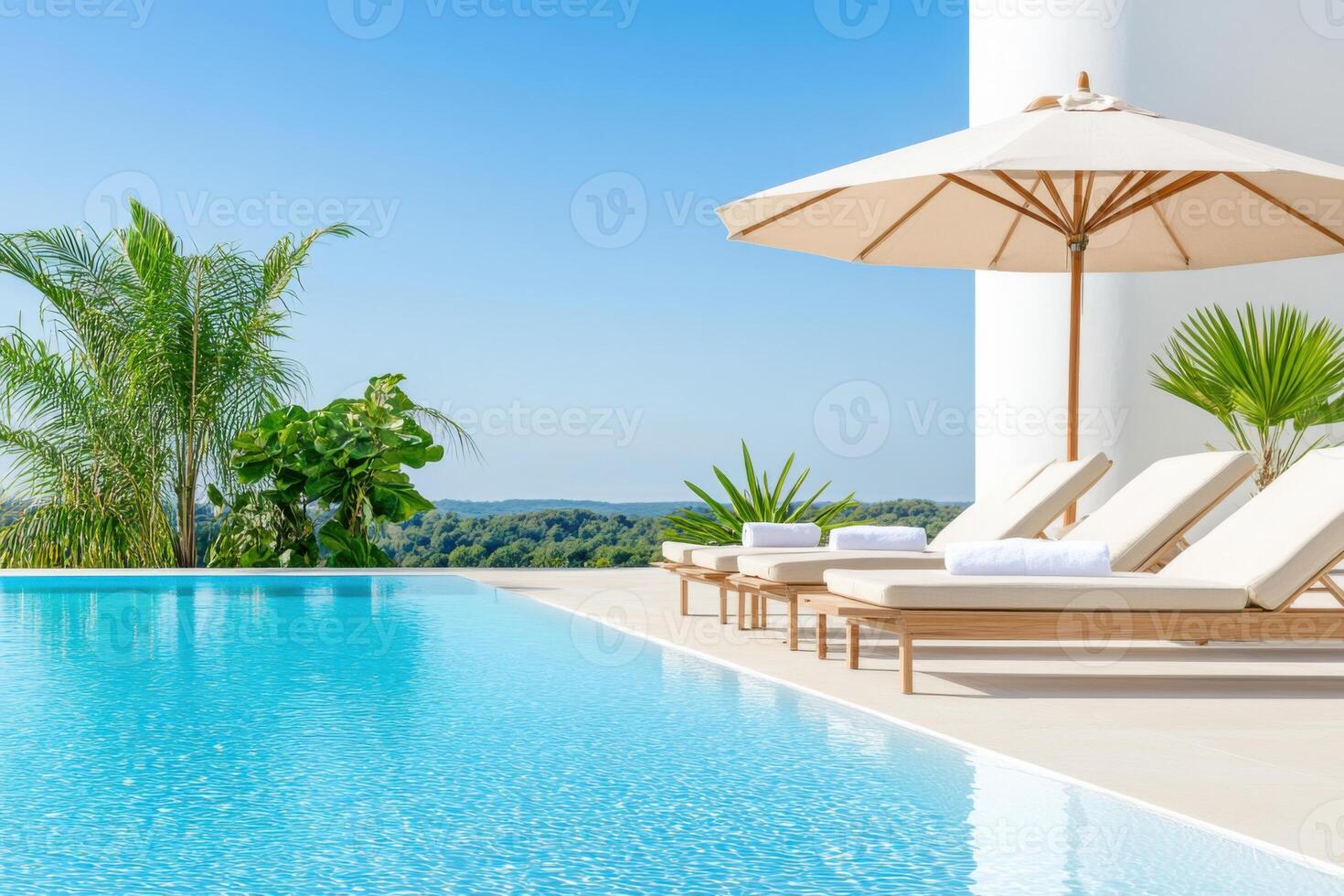 Stylish poolside patio featuring modern sun loungers and serene infinity pool reflecting the blue sky during sunny day photo