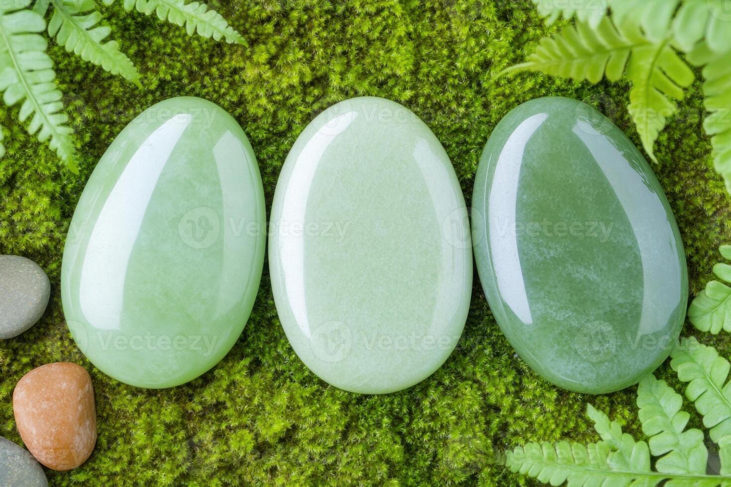 Elegant composition of polished green jade stones, soft moss, and delicate fern leaves creates a calming natural aesthetic photo