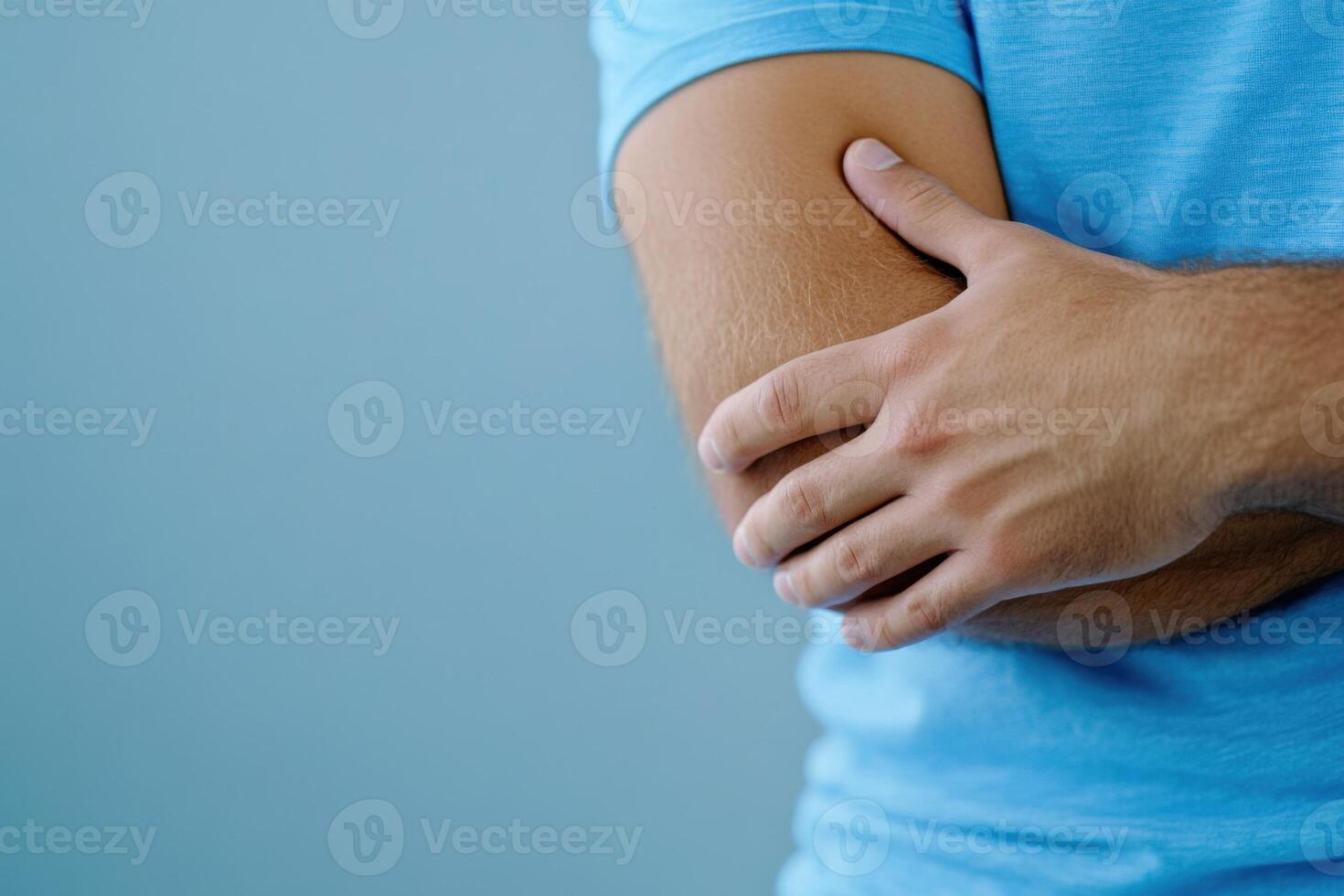 Close-up view of athlete in pain with swollen joint, focusing on injury to elbow during training session photo