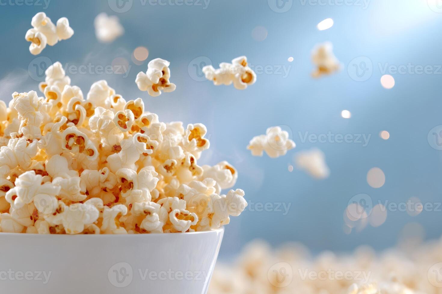 Bowl Overflowing with Freshly Popped Popcorn Exploding on a Blue Background photo
