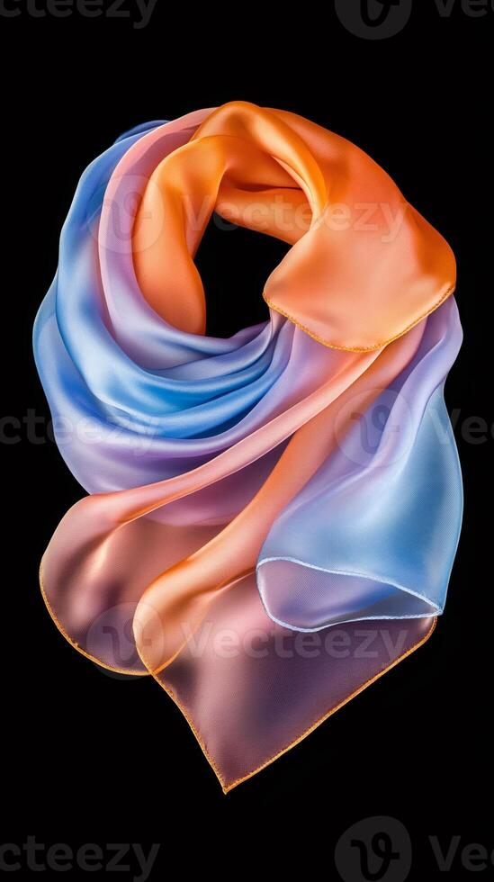 Silk scarf with orange and blue gradient is floating on black background photo