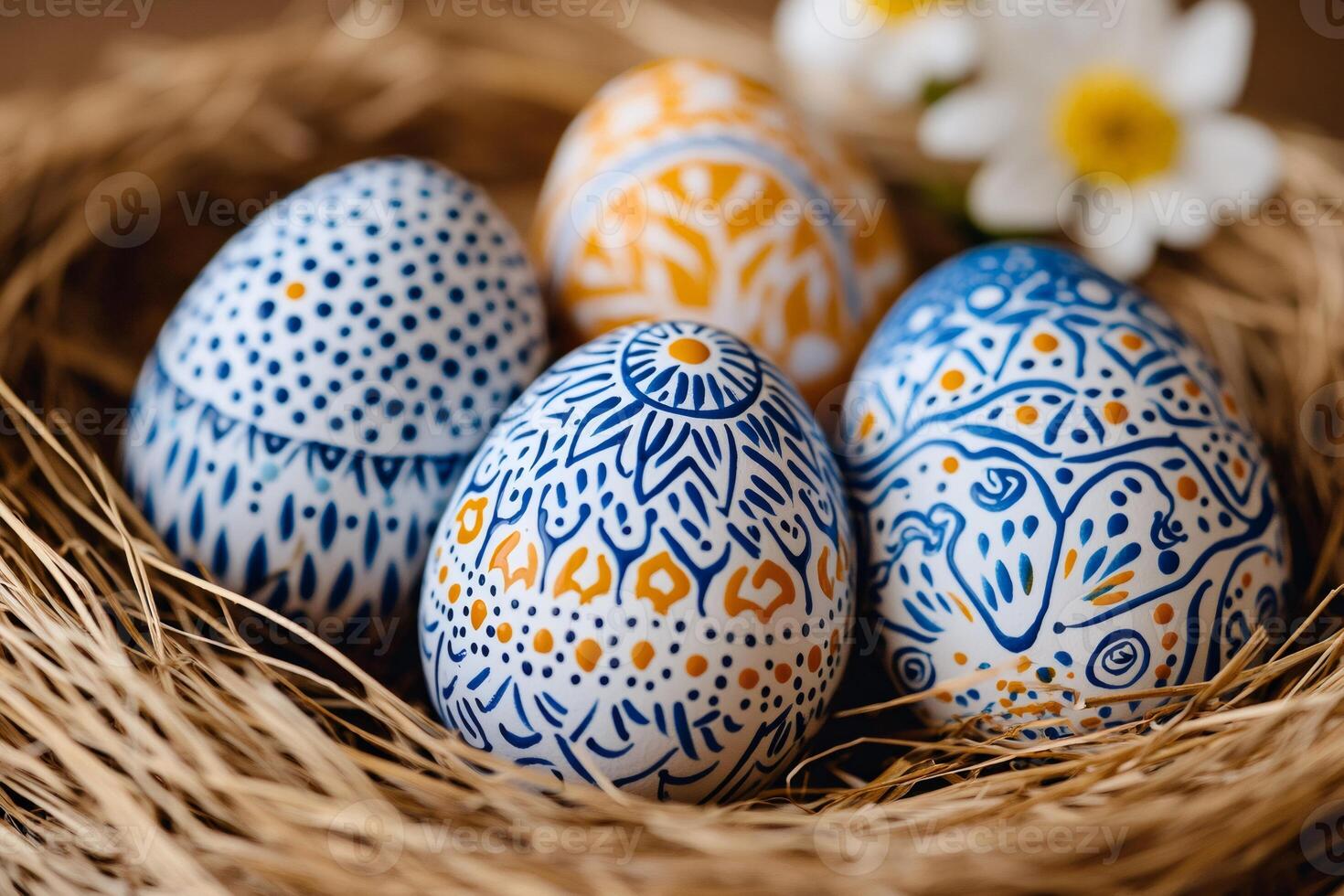 Hand-painted easter eggs resting in a nest with flowers photo