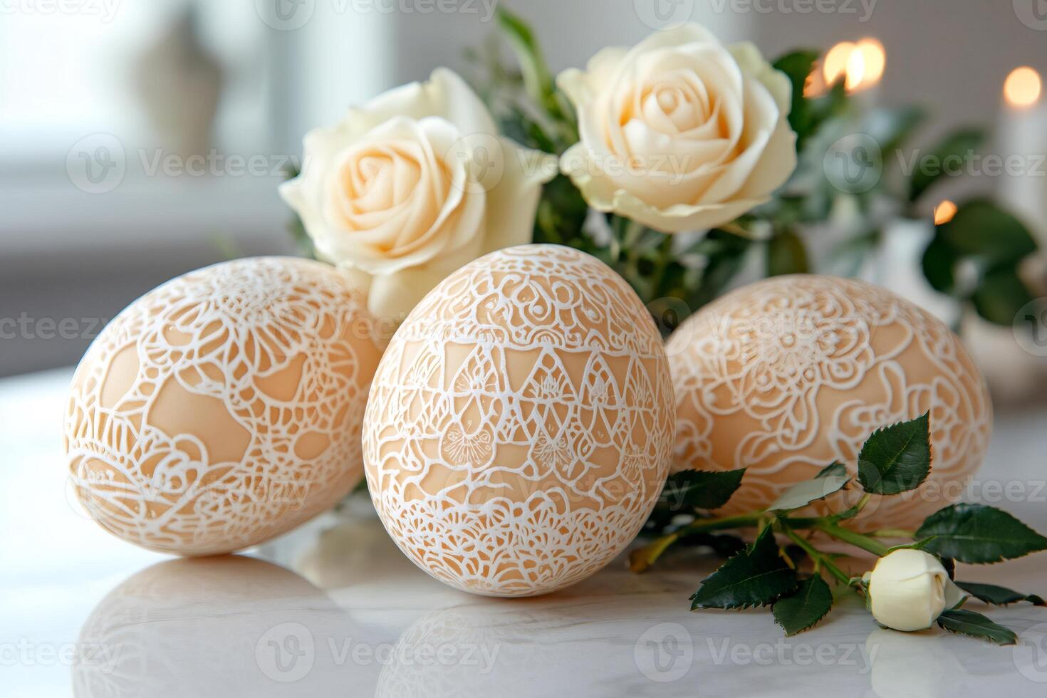 Easter eggs with lace ornament are lying on marble table near blooming roses photo