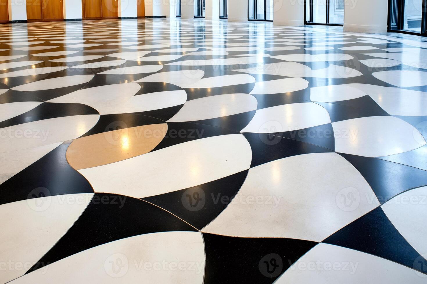 Shiny black, white and gold tiled floor creating an optical illusion in modern building photo
