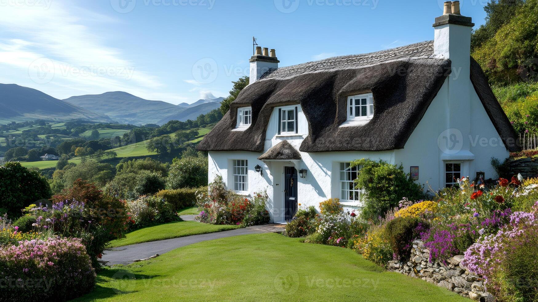 Picturesque thatched cottage nestled in a colorful garden overlooking Snowdonia National Park photo