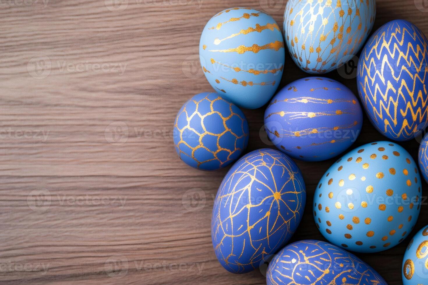 Easter eggs with gold ornaments are lying on a wooden surface photo