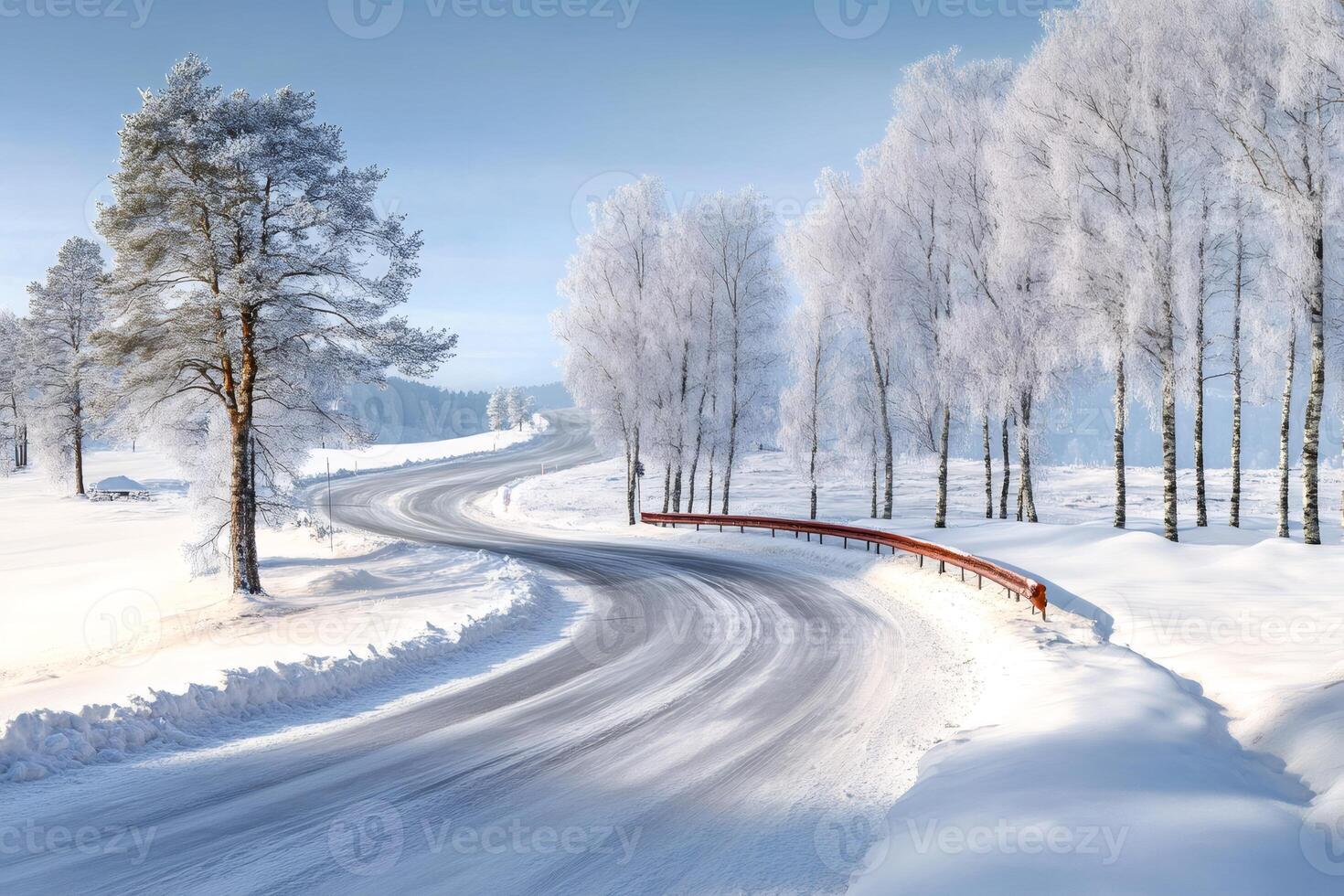Winding road passing through snowy trees in winter landscape photo