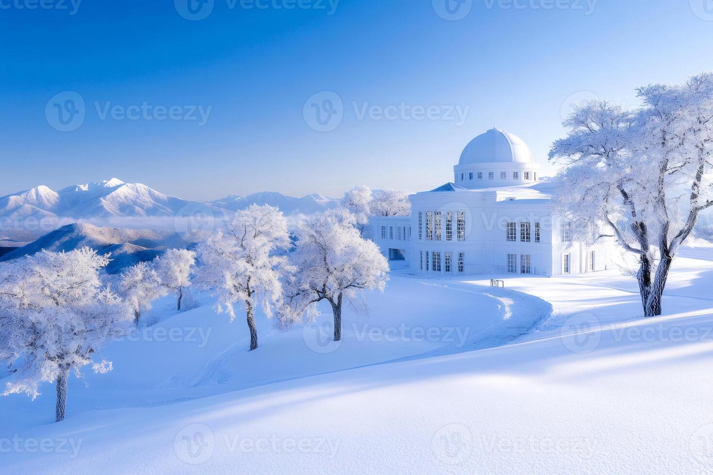 Snow covered trees and a white building with a dome in front of snowy mountains in Hokkaido, Japan photo