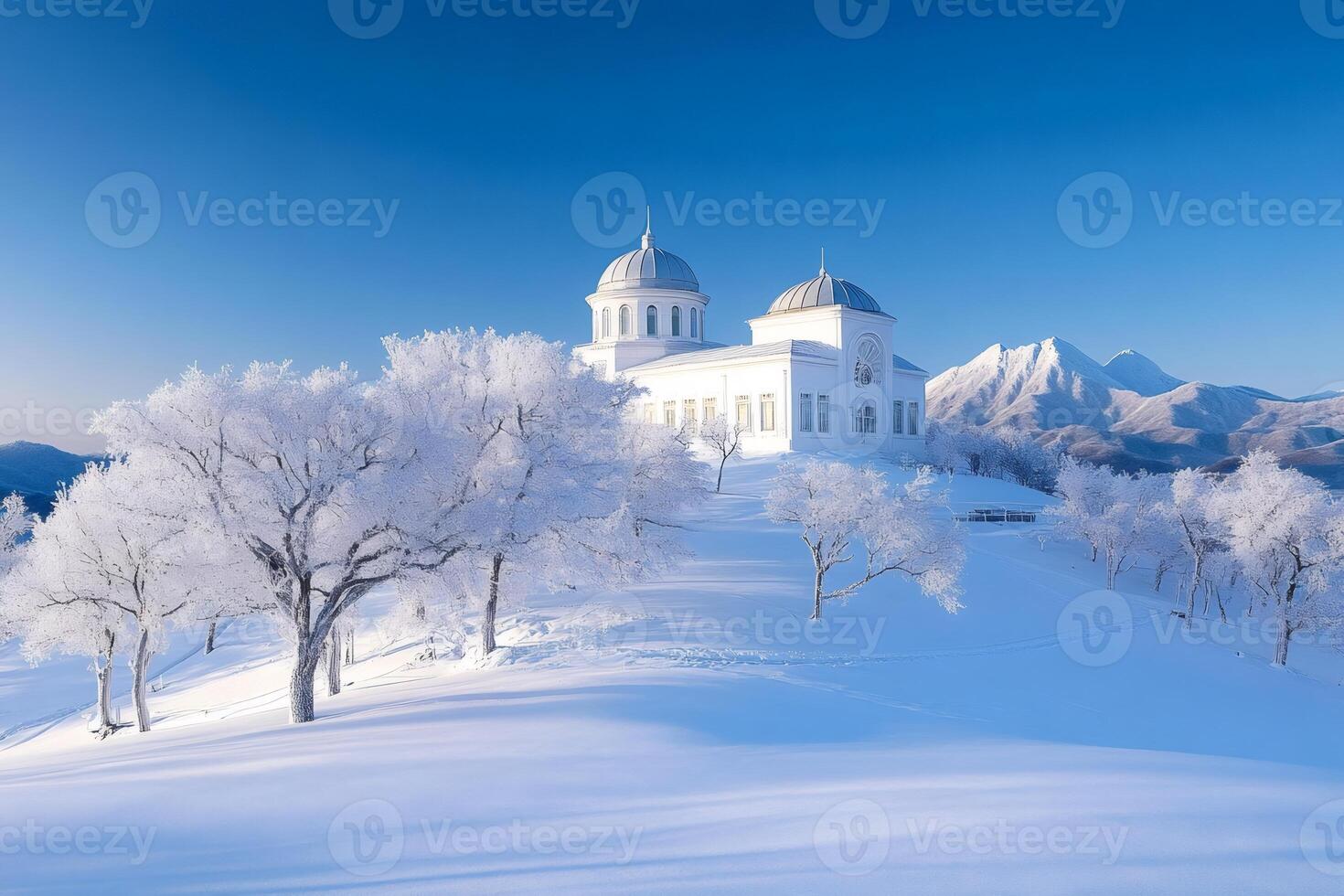 The white church of the snowy mountain is shining under the winter sun photo
