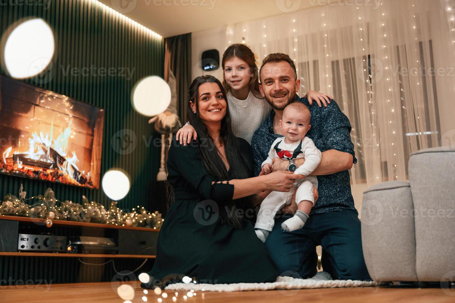 Happy family is sitting ,together at home. Celebrating New Year photo