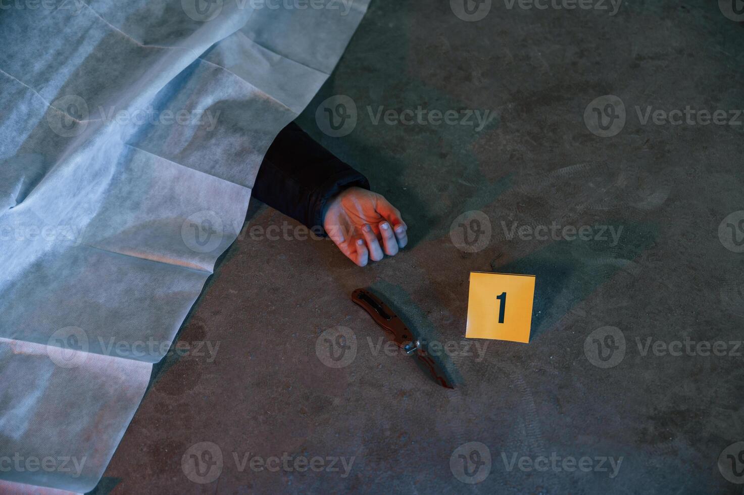 Dead body of a man is on the, ground, covered in white cloth. Conception of murder, homicide photo