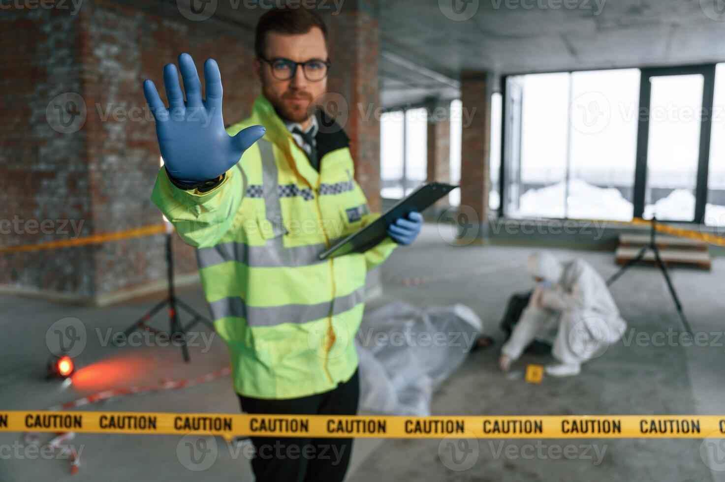 Stop, gesture by a hand, no trespassing. Detectives are collecting evidence in a crime scene near dead body photo
