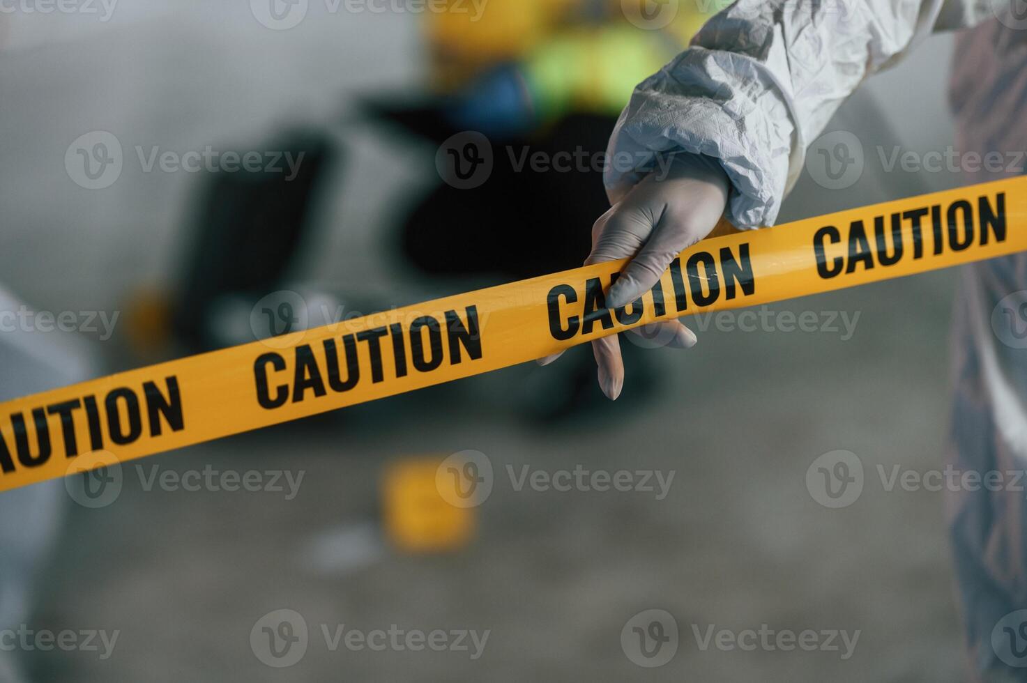 Close up view ,of caution police tape. Detectives are collecting evidence in a crime scene near dead body photo