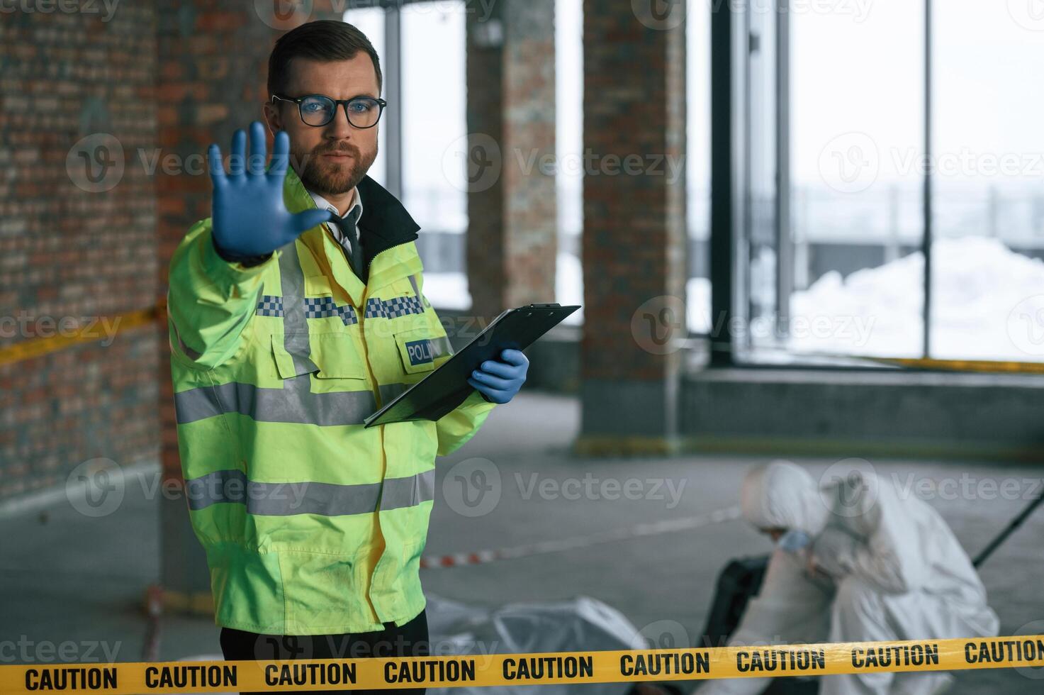 Stop gesture, by a hand, no trespassing. Detectives are collecting evidence in a crime scene near dead body photo