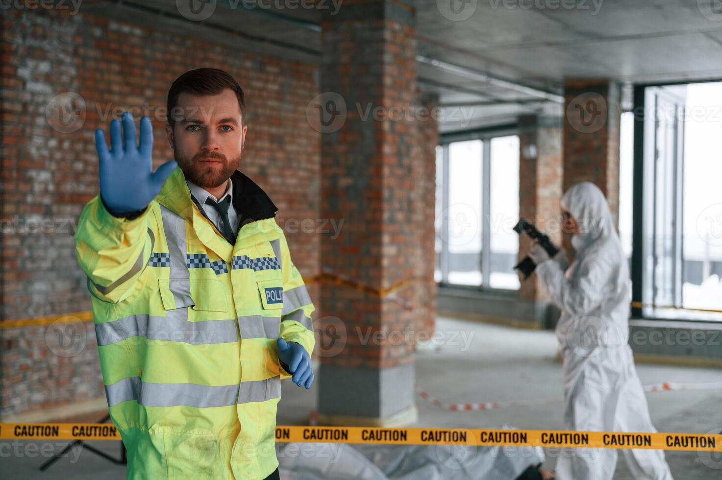 Stop gesture by ,a hand, no trespassing. Detectives are collecting evidence in a crime scene near dead body photo