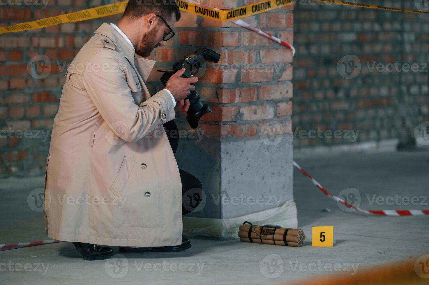 Detective i,n coat is on the crime scene with explosive bomb photo
