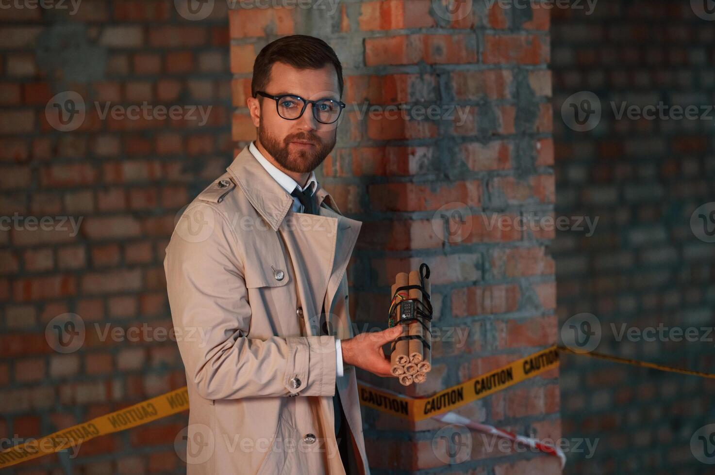 Detective in coat is on, the crime scene with explosive bomb photo