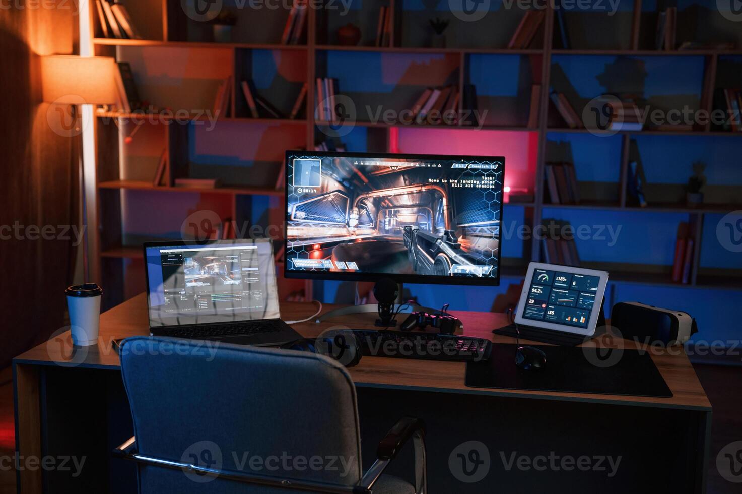 Computer with online ,first person shooter game launched. In dark room with neon lighting photo