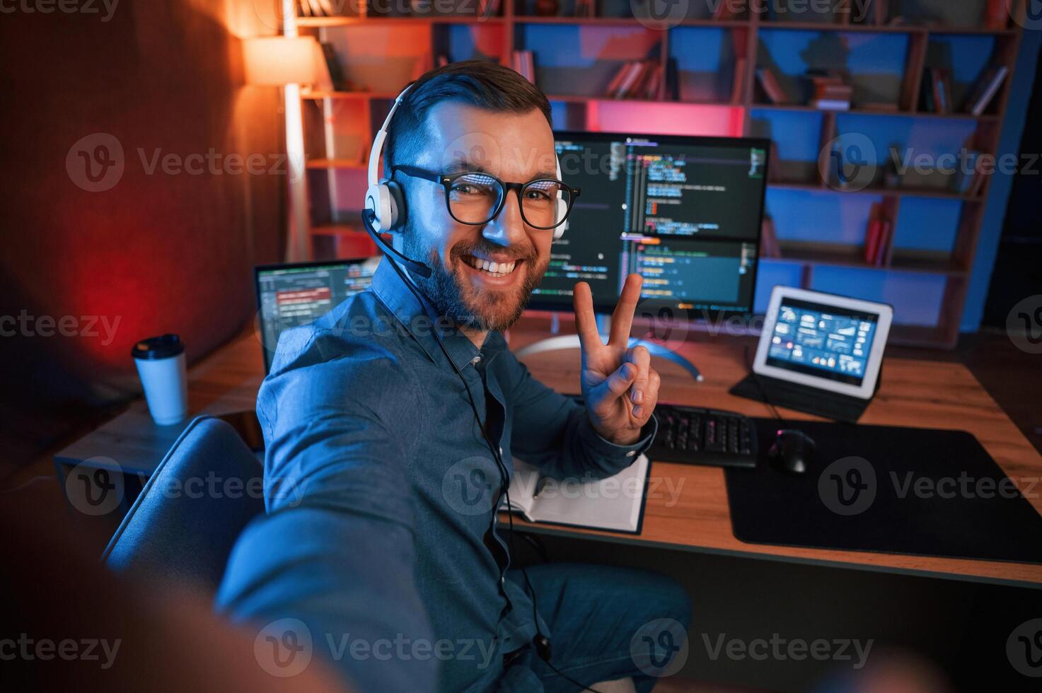 Professional ,,programmer is working indoors. Neon lighting photo