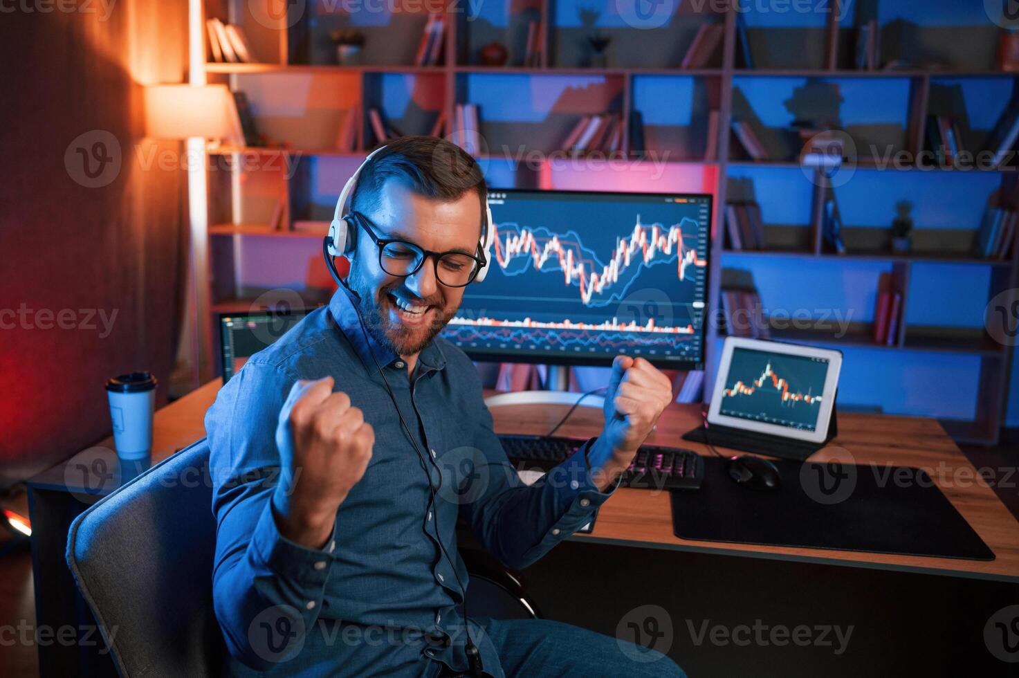Happy stock trader ,is working by pc indoors and celebrating success. Conception of exchange and money photo