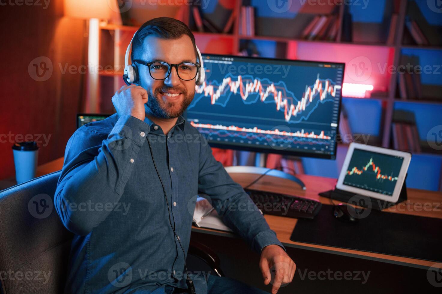 Stock trader is working by pc indoors. Conception of exchange and money photo