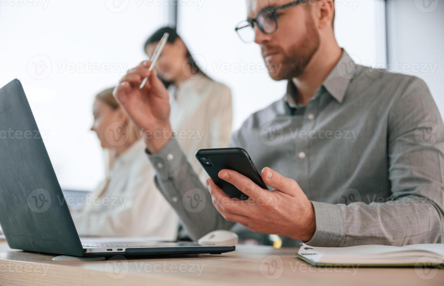 Side view of man that is sitting. .Successful team are working together in the office. Conception of business photo