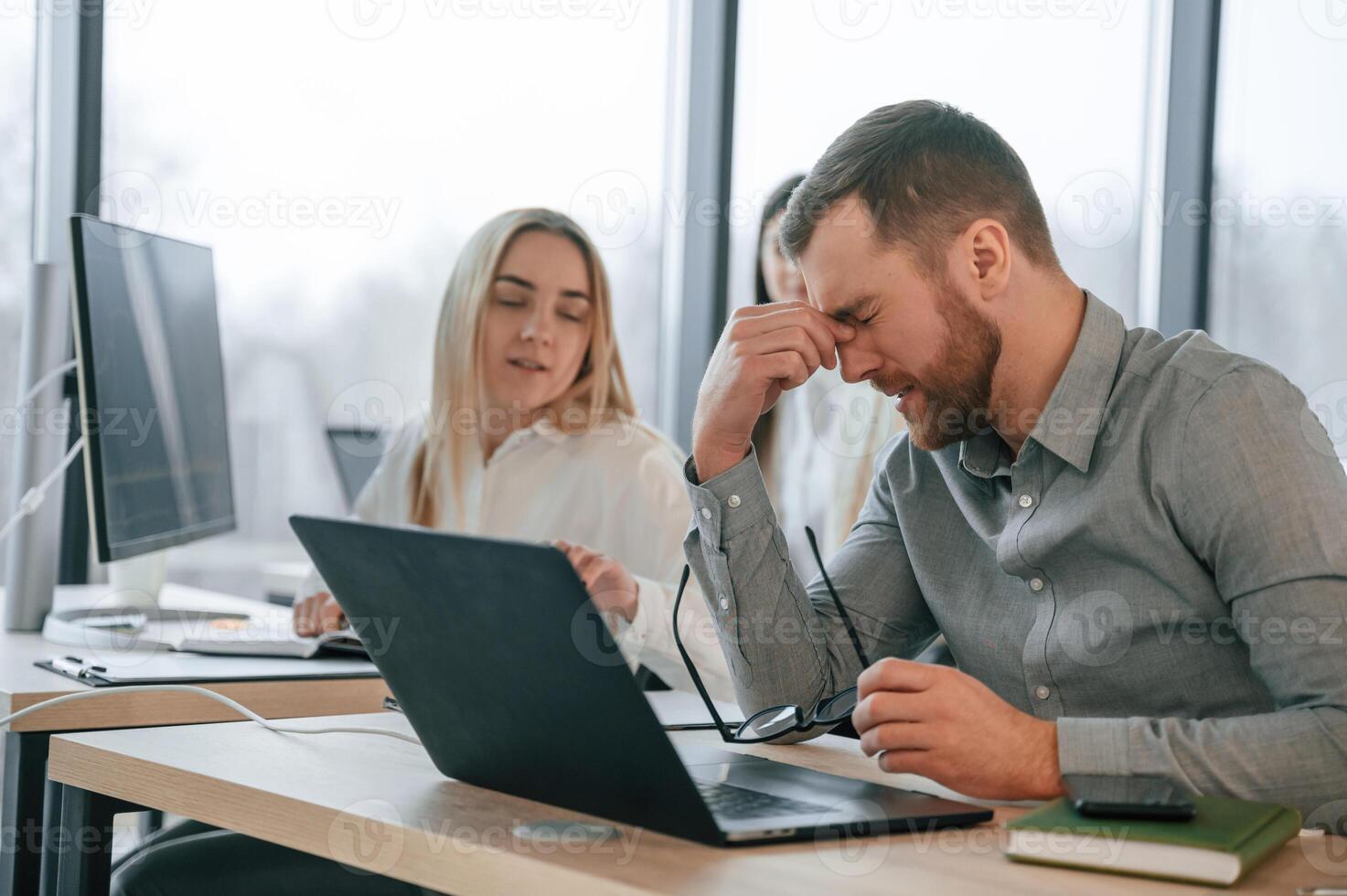 Man, is feelingm bad about failure. Team are working together in the office. Conception of business photo