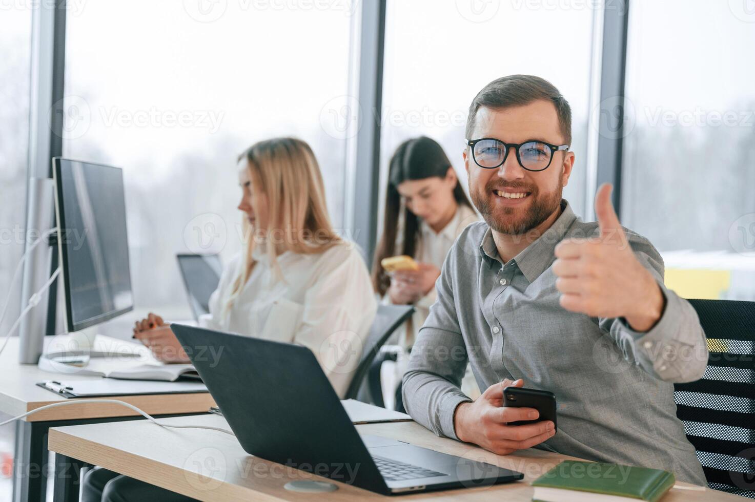 Front view of man.. Successfulm team are working together in the office. Conception of business photo