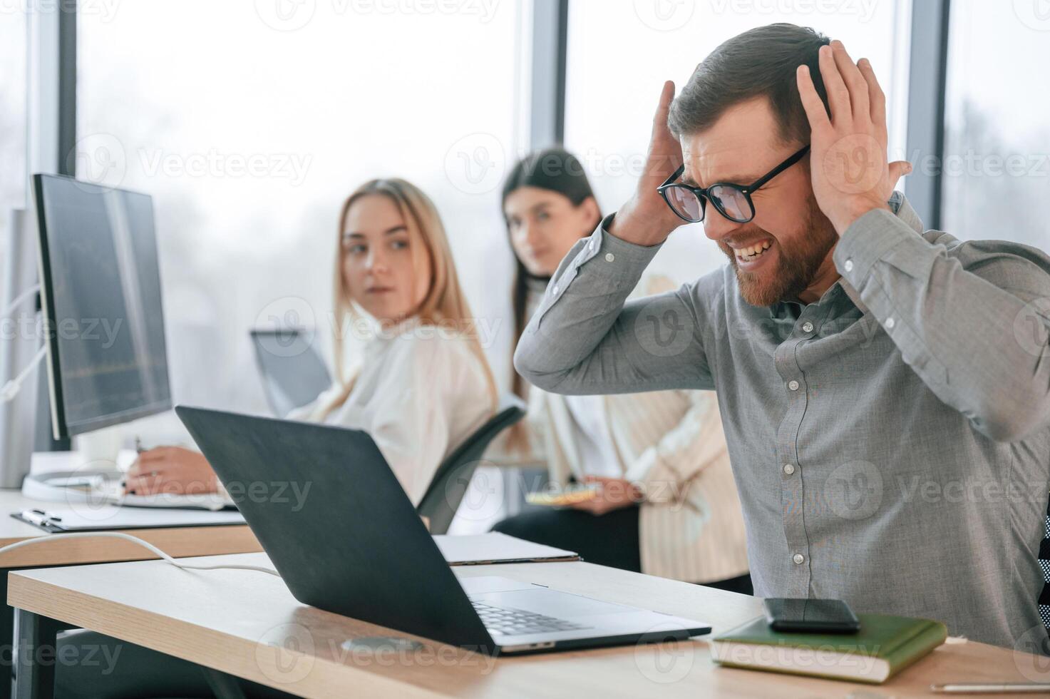Man, is feeling mbad about failure. Team are working together in the office. Conception of business photo