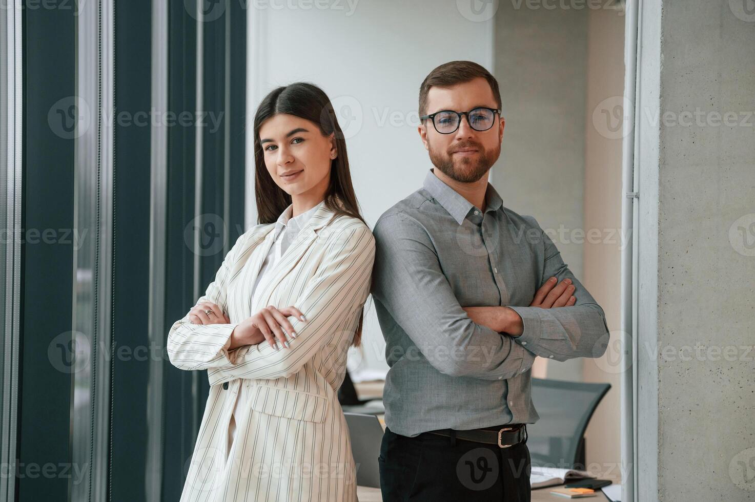 Man with woman is, standing and posing. Successful team are working together in the office. Conception of business photo