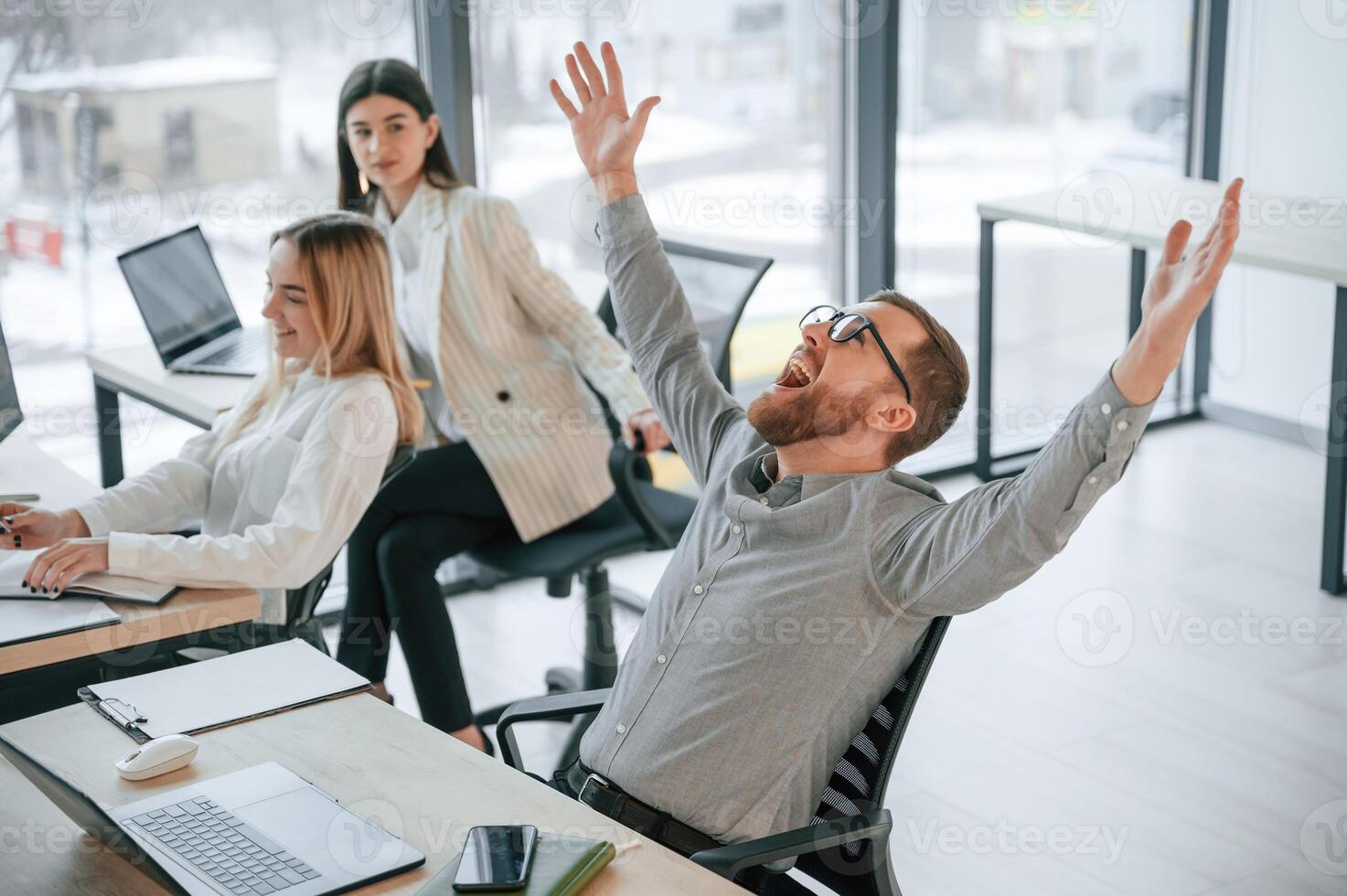 Man ism satisfied about results. Successful team are working together in the office. Conception of business photo