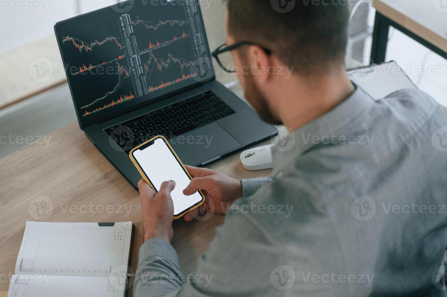 Using smartphone.. Businessman, in formal clothes is working in the office photo