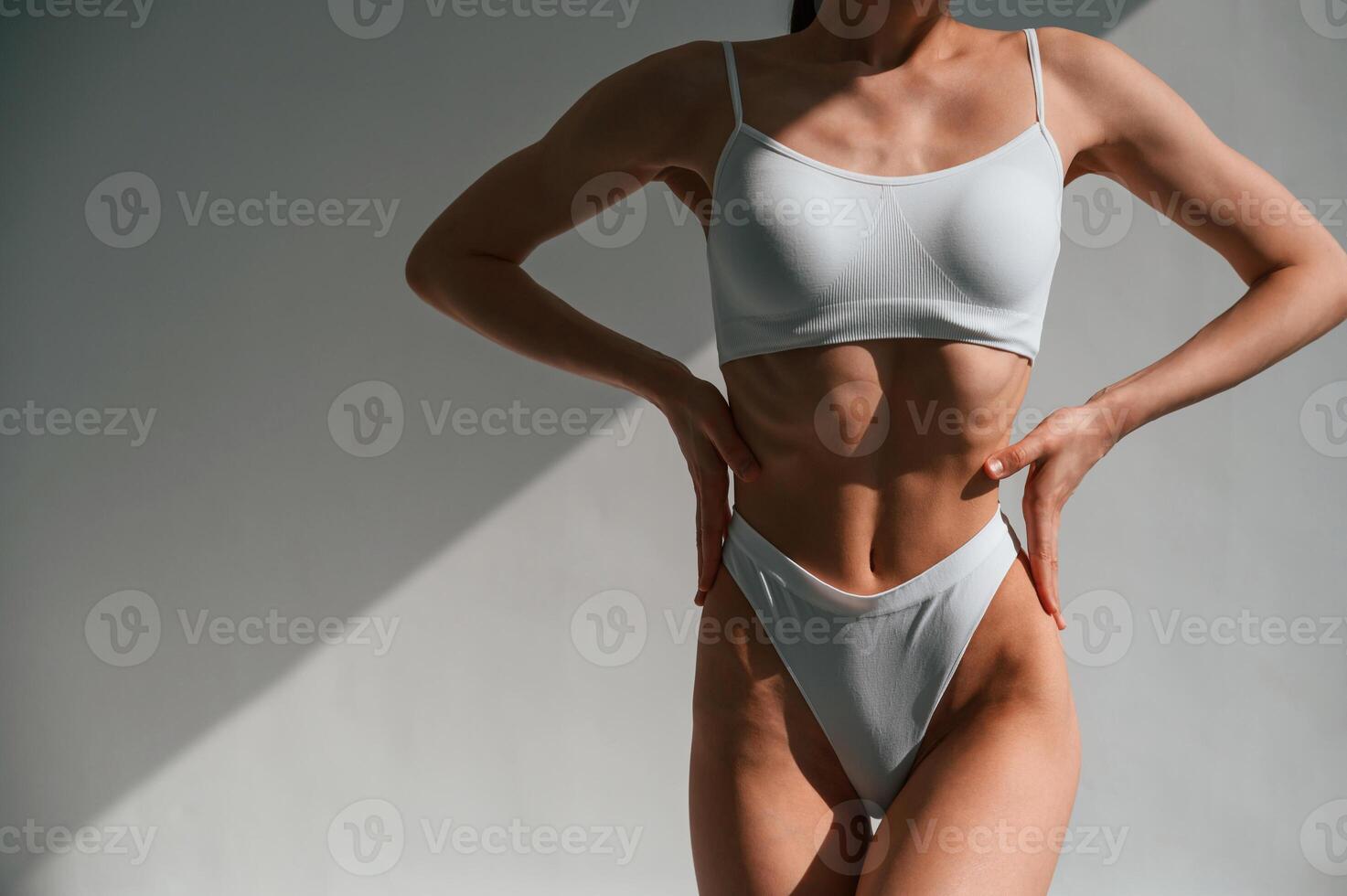 Close up, view of the body. Young caucasian woman is indoors in the studio photo