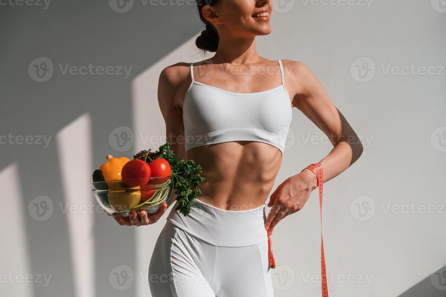 Conception ,of diet.. With vegetalbes and fruits. Young caucasian woman with slim body shape is indoors in the studio photo