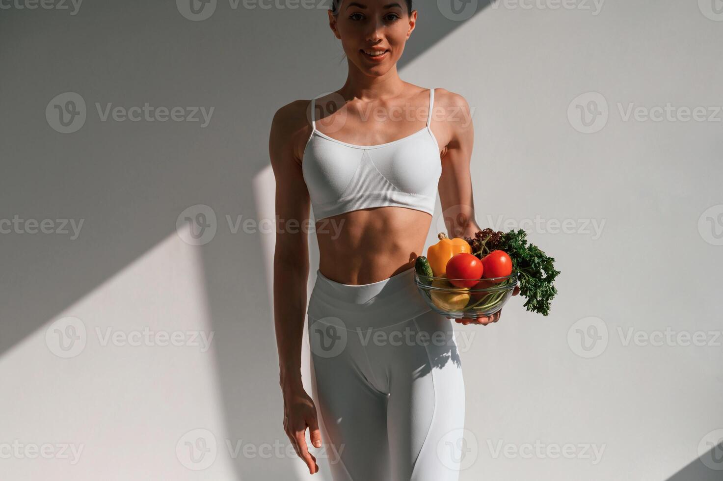 Conception ,of healthy ,eating. With fruits. Young caucasian woman with slim body shape is indoors in the studio photo