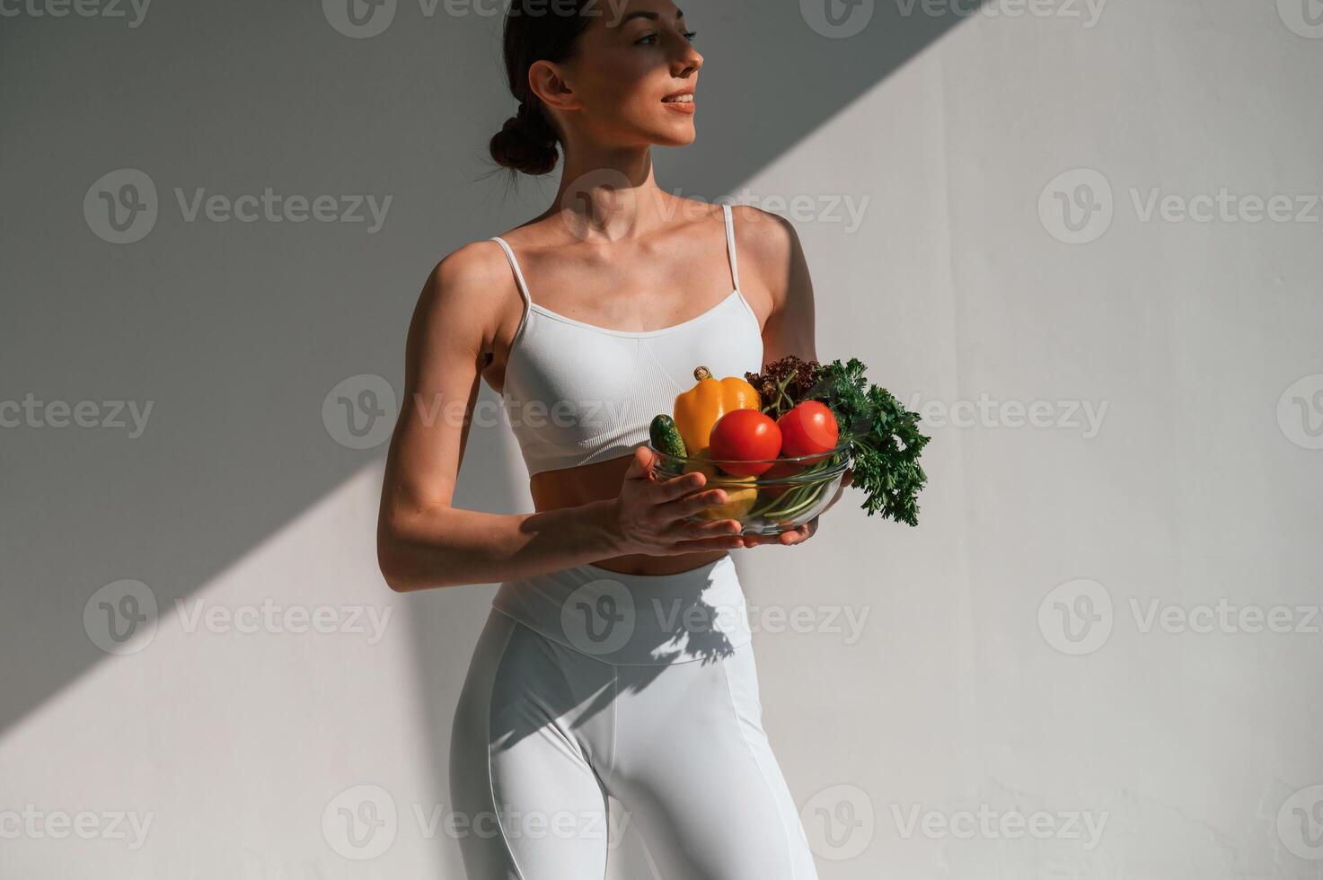 Conception, of, healthy eating. With fruits. Young caucasian woman with slim body shape is indoors in the studio photo