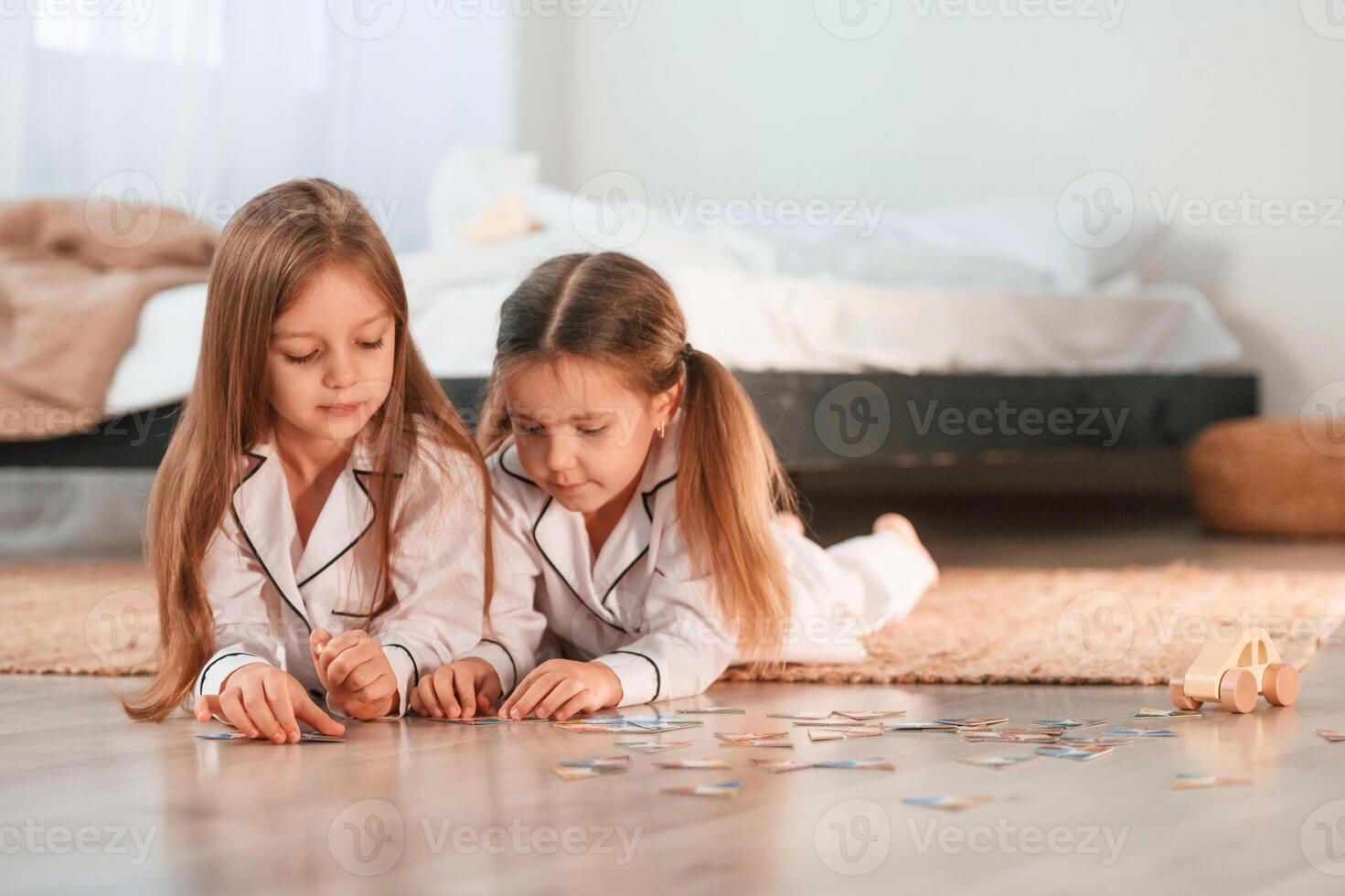 Card game. Two little girls are playing and having fun together in domestic room photo