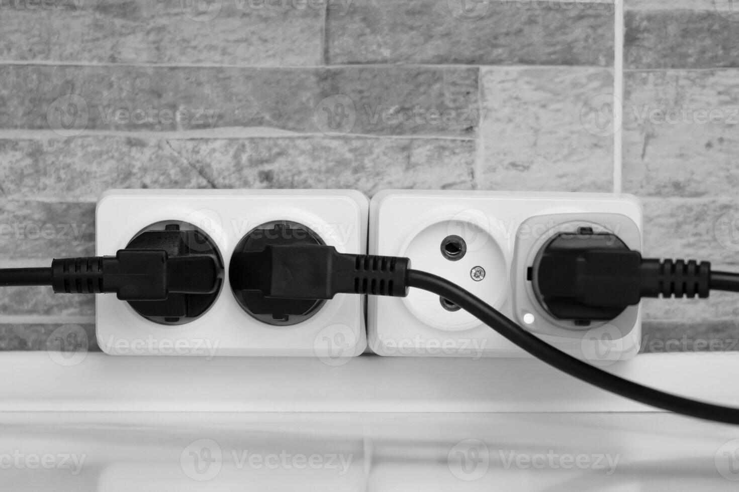 electrical white socket with black plugs photo