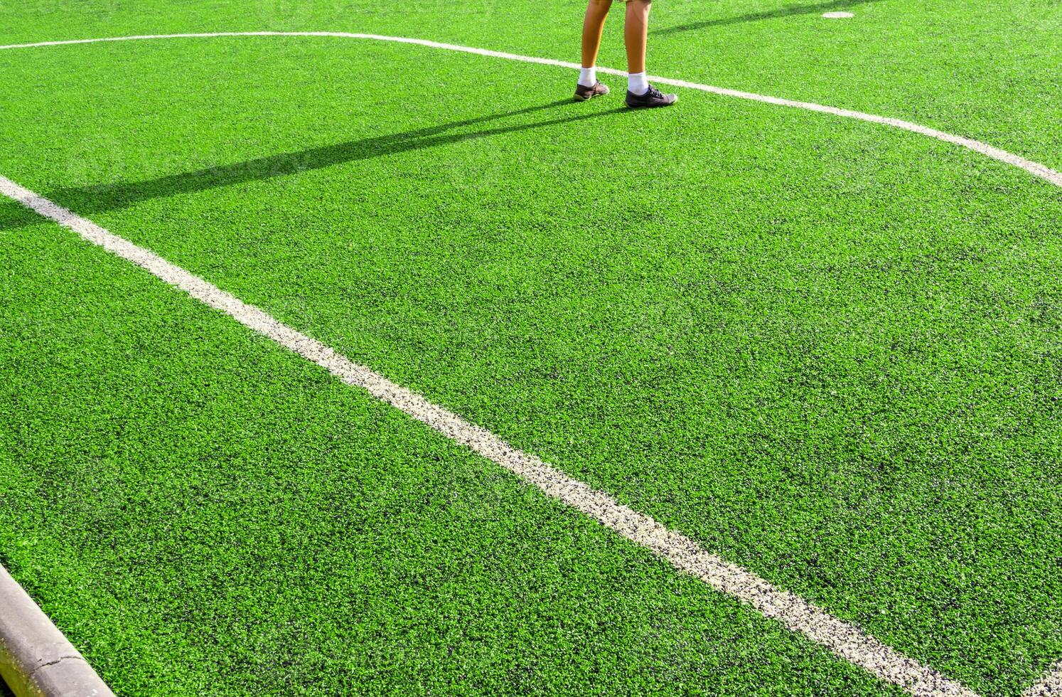 Child play on the artificial turf of the school photo