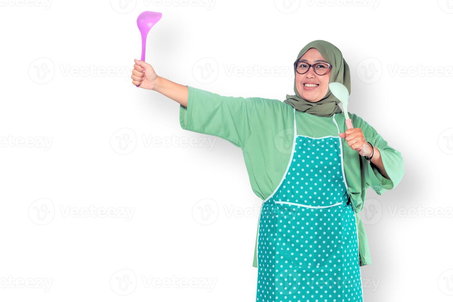Happy Muslim Woman Cooking with Kitchen Utensils photo