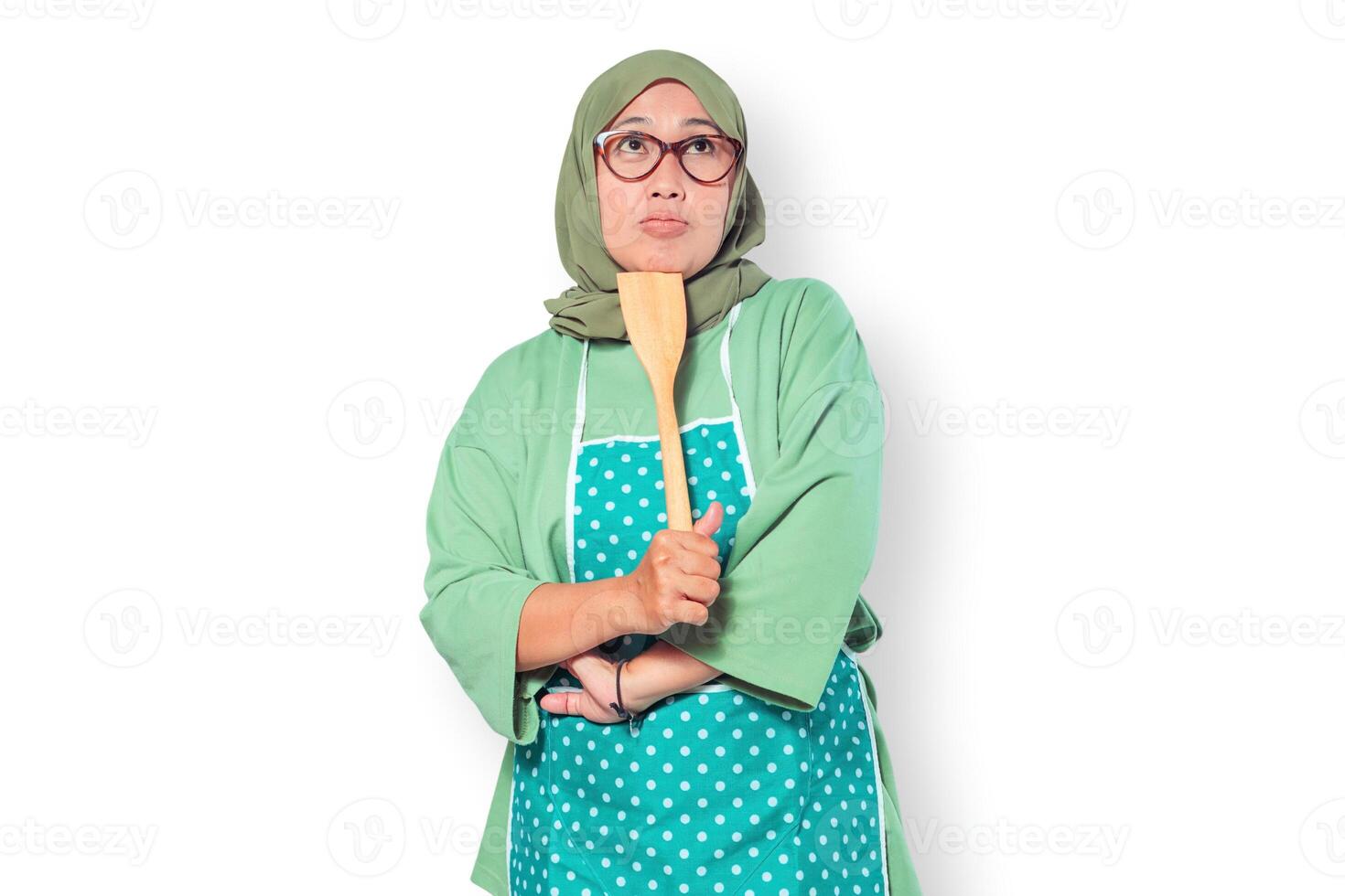 Confused Muslim Woman Chef Holding Wooden Spatula photo