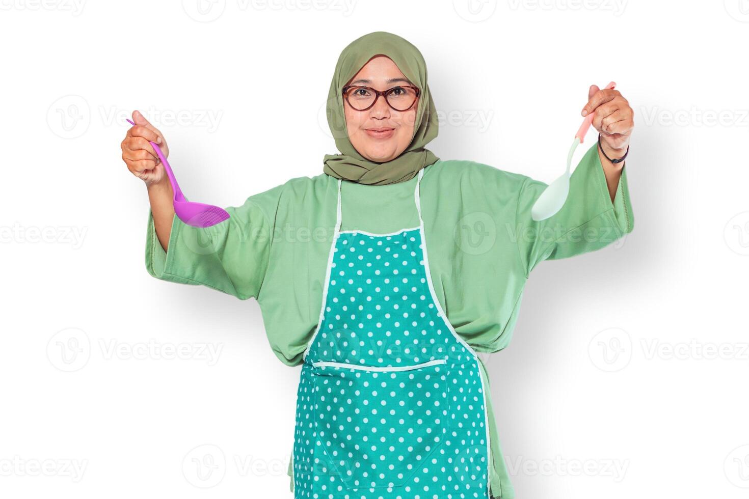 Happy Muslim Woman Holding Cooking Utensils photo