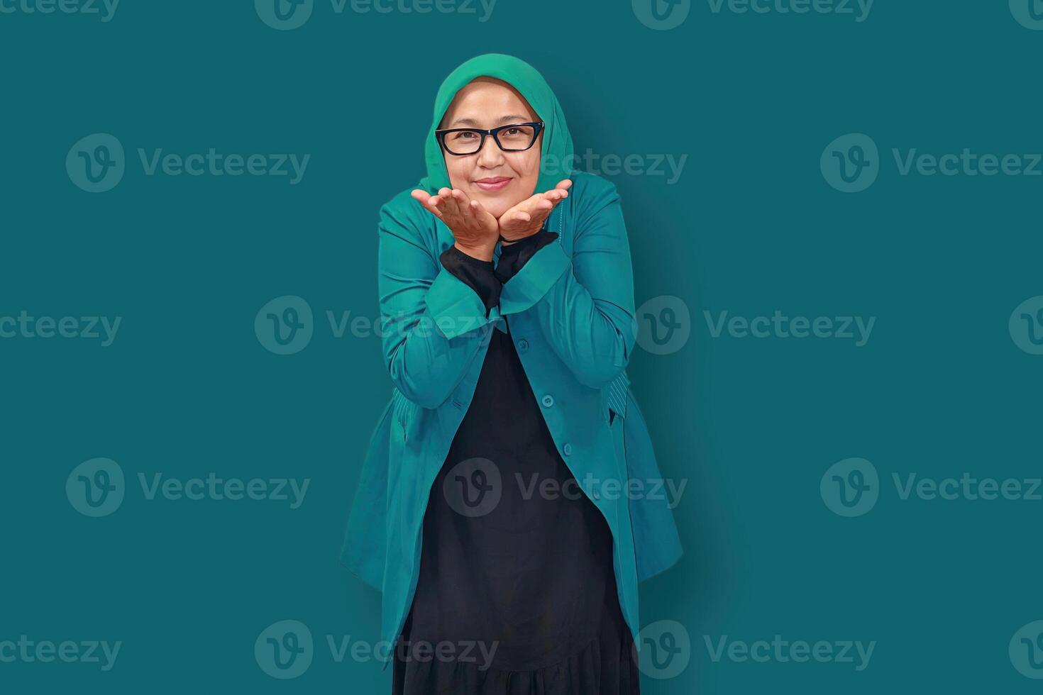 Happy Senior Muslim Woman Blowing a Kiss to Camera photo